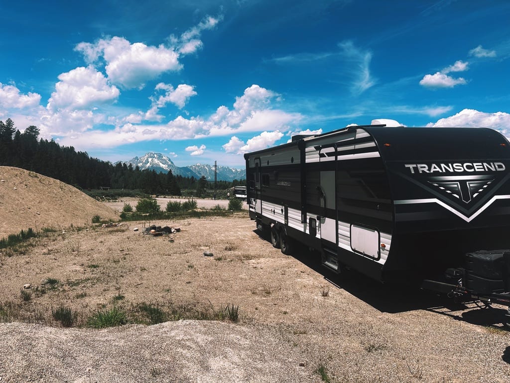 The travel trailer we call home, parked beneath the Tetons